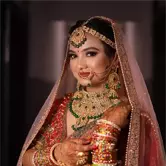 Soft glam makeup with bold red lips, sleek hair, and traditional jewelry for festive look